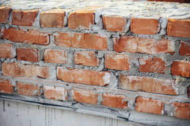 Beton temeli çimento kaplı tuğlalar, ev inşa süreci. Beton temeller üzerine döşenmiş kırmızı tuğlalar. İnşaat alanında inşaat malzemeleri