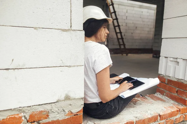 Young Female Architect Tablet Checking Blueprints While Sitting Window New — Photo