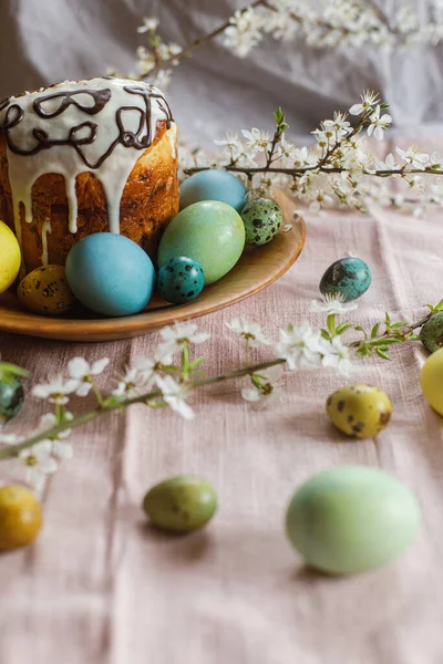 复活节快乐 自制的东方面包和天然染色的东方鸡蛋 有春天的花在木制的盘子在乡村的桌子上 传统复活节食品 — 图库照片