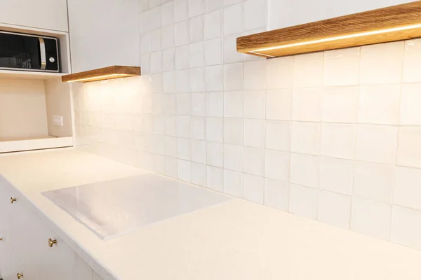 现代最小厨房设计 时尚的白色电饭锅 带有黄铜把手的厨房橱柜 花岗岩柜台 木制架子和新丑闻中的家用电器 现代厨房内部 — 图库照片