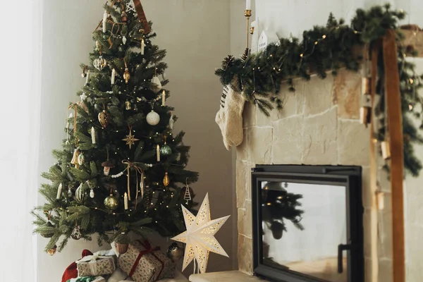 モダンファームハウスでマントルとスタイリッシュなクリスマスツリーに掛かる居心地の良いストッキング 暖かいニットのストッキングとスタイリッシュな装飾とロシアのクリスマスの暖炉 大気の冬のリビングルーム — ストック写真