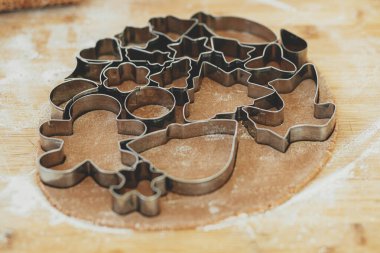 Zencefilli kurabiye yapıyorum. Ahşap tahta kesicili zencefilli ekmek hamuru un, baharat pişirme, modern beyaz mutfakta şenlikli süslemeler.