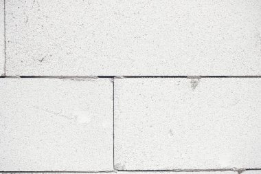 Aerated concrete blocks wall. Autoclaved aerated concrete blocks  masonry close up with adhesive. Process of house building at construction site. Aerated concrete blocks wallpaper pattern