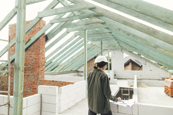 Young Female Architect Tablet Checking Blueprints Wooden Roof Framing Modern — Stockfoto