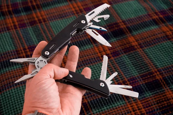 Man holding multi tool in hand close up view