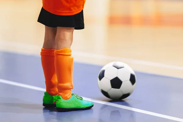 Football futsal player with ball. Futsal floor and  players on training. Sports background. Indoor soccer sports hall. Youth futsal league. Indoor football classic ball