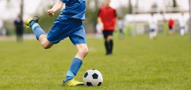 Young Soccer Players Running After the Ball. Running Soccer Football Players. Footballers Kicking Football Match game. Soccer Stadium in the Background