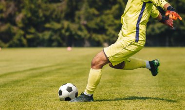 Goalie Kick on the Pitch During Match. Soccer Football Goalkeeper Goal Kick. Goalkeeper Restarting Play in a Game 