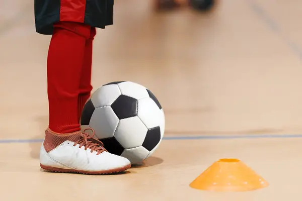Futsal Training Drill For School Children. Kids Playing Sports Games at Indoor Field. Legs of Little Anonymous Boy WIth Soccer Ball. Player in Soccer Shoes and Red Socks