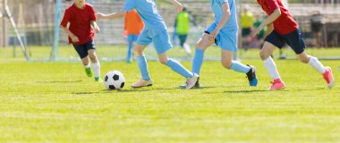 Futbol Gençlik Takımları Açık Hava Turnuvası. Genç Futbolcular Yarışması. Erkekler futbol topunu tekmeliyor. Arka plandaki Futbol Stadyumu