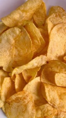Crispy potato chips, a quick snack. Close-up of spinning potato chips.