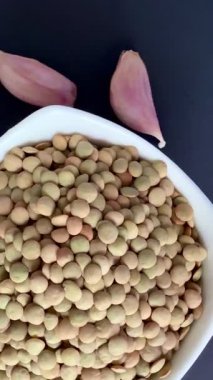 Bowl of lentils with garlic and cloves Healthy, wholesome, plant-based food.