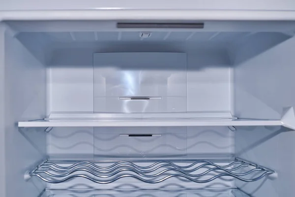 Empty refrigerator with its shelves suitable as a background