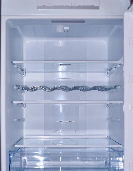 Empty refrigerator with its shelves suitable as a background