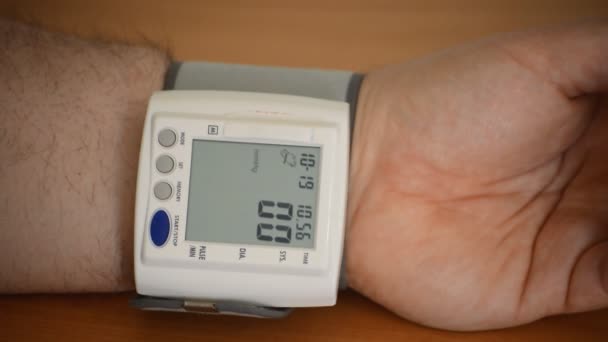 Footage Man Taking Blood Pressure Test His Hand Digital Device — Stock Video