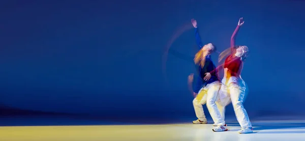 若い男性と女性の肖像は 混合光と濃い青の背景の上に孤立して踊る ヒップホップ フライヤー 若者文化 アクティブライフスタイル アクション ストリートダンス 広告の概念 — ストック写真