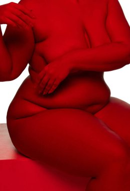 Cropped image. Beautiful nude woman with red light on her skin posing over white background. Parts of body. Concept of natural beauty of female body, bodypositive, fashion, art. Femininity