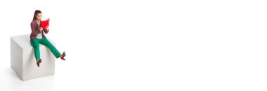 Young business woman wearing modern office style clothes sitting and looking at diary isolated on white background. Business, work, career, education concept. Banner with copy space for ad