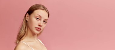 Portrait of young beautiful girl without makeup on face. Model with long healthy blonde hair looking at camera. Concept of skin care, beauty, spa, anti-aging procedures. Banner