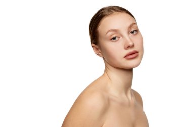 Half-length portrait of young beautiful girl without makeup on face. Model with bare shoulders. Concept of purity, skin care, beauty, spa, anti-aging procedures. Copy space for ad