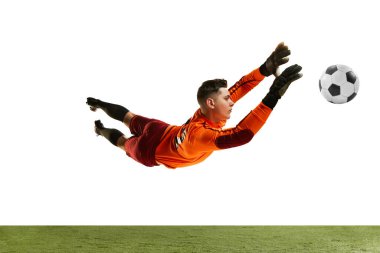 Dynamic portrait of professional soccer goalkeeper in sports uniform jumping and catching football ball isolated over white background. Concept of sport, action, motion, goals.