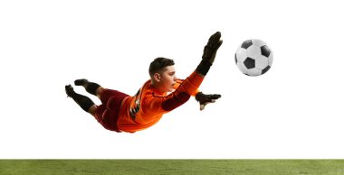 Dynamic portrait of professional soccer goalkeeper in sports uniform jumping and catching football ball isolated over white background. Concept of sport, action, motion, goals.