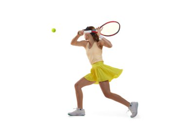 Back view of professional young female tennis player in sports uniform training with tennis racket isolated over white background. Concept of sport, health, strength, action, motion, lifestyle.