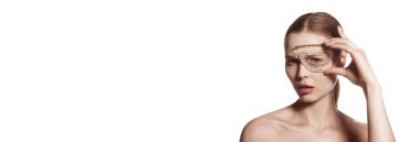 Young woman, female patient isolated on white studio background. Concept of lifting. Making beauty, modifying face to make non-surgical or surgical correction, plastic surgery. correction asymmetry.