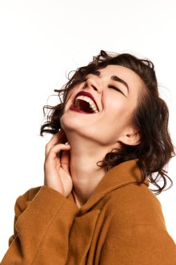 Happiness. Half-length portrait of composed sensual high fashion model, girl in jacket on naked body laughing. Concept of beauty, emotions, fashion, style, aspiration