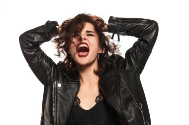 Shout. Closeup portrait of young sexy emotional hipster woman in leather jacket expressing vivid emotions over white background. Concept of youth lifestyle, womens rights, diversity, ad