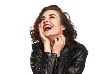 Happiness. Excited emotional young stylish woman in leather black jacket laughing over white background. Concept of youth lifestyle, womens rights, diversity, ad