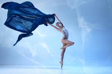 Aesthetic of movements. Charming ballerina posing with silk fabric over blue background. Ballet with silk. Concept of classic ballet, inspiration, beauty, dance, creativity clipart