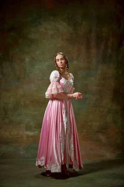 stock image Elegant lady. Portrait of beautiful blond girl, princess wearing fancy pink dress and standing with folded hands over vintage texture background. Concept of medieval, beauty, old-fashioned clothes, ad