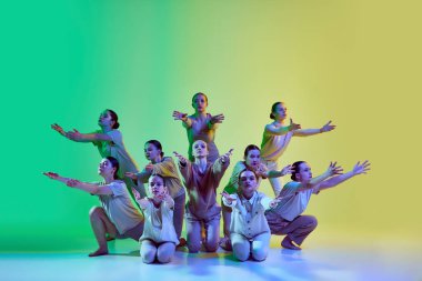 Gençlik koreografisi stüdyosu. Bir grup genç ve sevimli kız, neon ışıklarıyla arka planda müzik eşliğinde ilerliyorlar. Modern serbest stil dansı, hareketler, hobi, yaratıcılık konsepti, reklam
