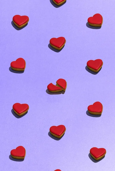 Cookies in the shape of heart on dessert top view. Food pattern with sweet bakery over violet background flat lay top-down composition. Find the difference. Concept of food, diet, cooking, design, ad