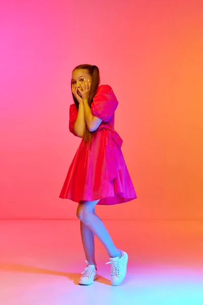 Scared Little Girl Festive Dress Ponytails Posing Pink Neon Background — Stock Photo, Image