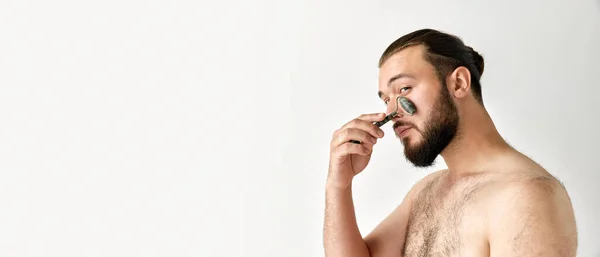 Banner Man Looking Away Who Massages Face Roller Grey Background — Stock Photo, Image