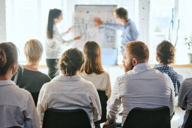 Business and entrepreneurship symposium. Speakers giving talk at business meeting. Rear view of unrecognized participant in audience. Training, planning, learning, coaching, business concept clipart