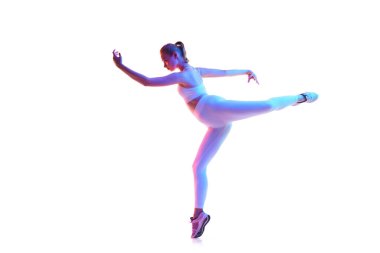 Spor kıyafetleriyle poz veren esnek genç bir kadının uzun portresi neon ışıkta izole edilmiş beyaz arka plan. Spor anlayışı, fitness, sağlıklı yaşam tarzı, güç, dans, gençlik, reklam. Boşluğu kopyala