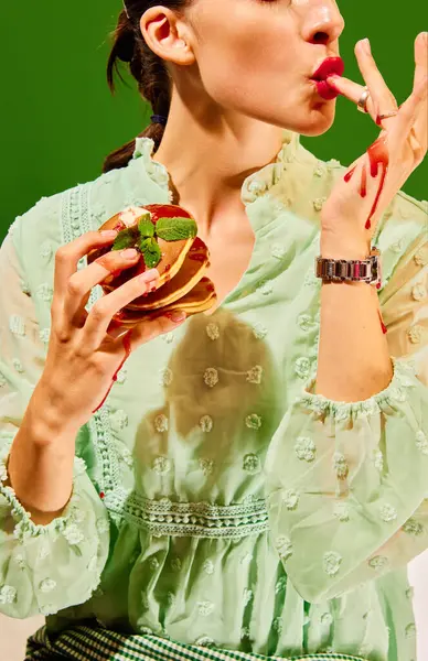 Breakfast. Food pop art photography. woman holding sweet pancakes, licking fingers in jam. Vintage, retro 80s, 70s style. Complementary colors. Concept of food, fashion, style, taste. Ad