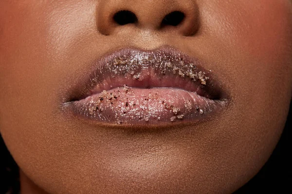 stock image Closeup view of African-American woman with lips covered in sugar. Exfoliate spa treatment for lips. Concept of beauty, make-up, cosmetology, spa treatments, cosmetic products. Ad