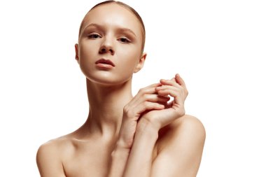 İyi korunmuş, pürüzsüz tenli ve beyaz stüdyo arka planına karşı doğal makyajlı güzel esmer kadın portresi. Doğal güzellik insanları, kişisel bakım, kadın sağlığı kavramı.