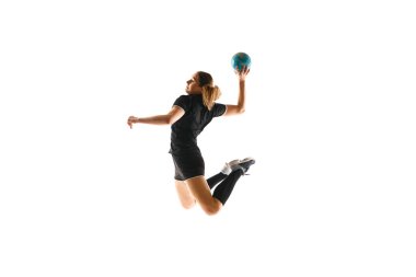 Professional handball player in action against white background, exhibiting strength and agility in ball handling. Concept of professional sport, movement, dynamic, workout, championship. Ad
