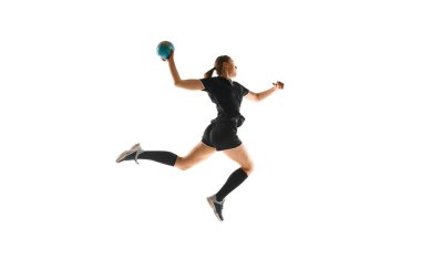 Female handball enthusiast executing precise throw, emphasizing the sports energy and athleticism against white background. Concept of professional sport, movement, dynamic, workout, championship. Ad