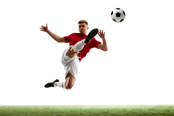 Soccers aerial ballet. Balletic world of soccer. Skilled athlete executes elegant mid-air pass against white studio background. Concept of sport games, hobby, energy, world cup season, movement. Ad