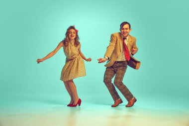 Çekici bir çiftin geçmişe dönük dans figürleri naneli arka planda dans ediyorlar. Aşk kavramı, ilişki, müzik, enerji, mutluluk, ruh hali, eylem. ad