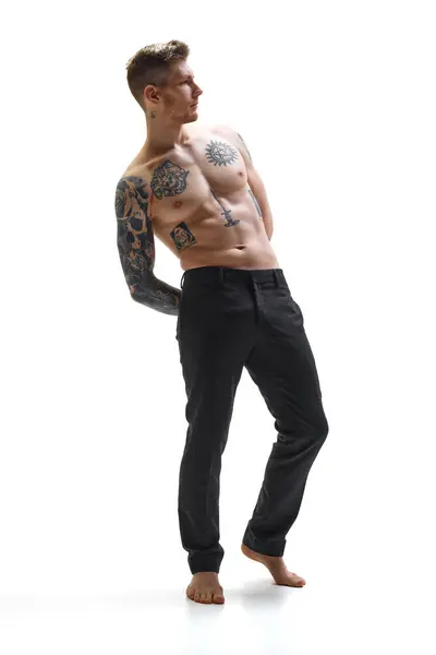 Tattooed Brutal Young Man Posing Demonstrating His Perfect Muscular Body Royalty Free Stock Photos