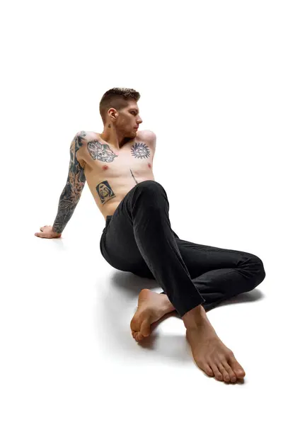 Tattooed Handsome Man Wearing Black Pants Sitting Posing White Studio Royalty Free Stock Photos