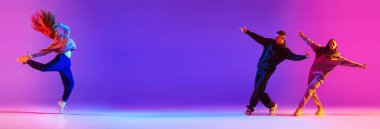 Pankart. Genç aktif çift, erkekler ve kızlar, Neon 'daki gradyan stüdyo geçmişine karşı hip hop. Çağdaş dans tarzı, gençlik, hobi, aksiyon ve hareket kavramı. Ad