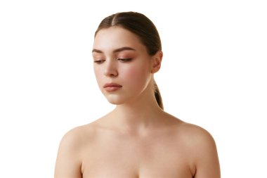 Kadınlık. Tarafsız makyajlı güzel esmer kızın portresi beyaz stüdyo arka planına bakıyor. Uzayı kopyala Doğal güzellik kavramı, yaşlanma karşıtı tedavi, sağlık, gençlik. Ad